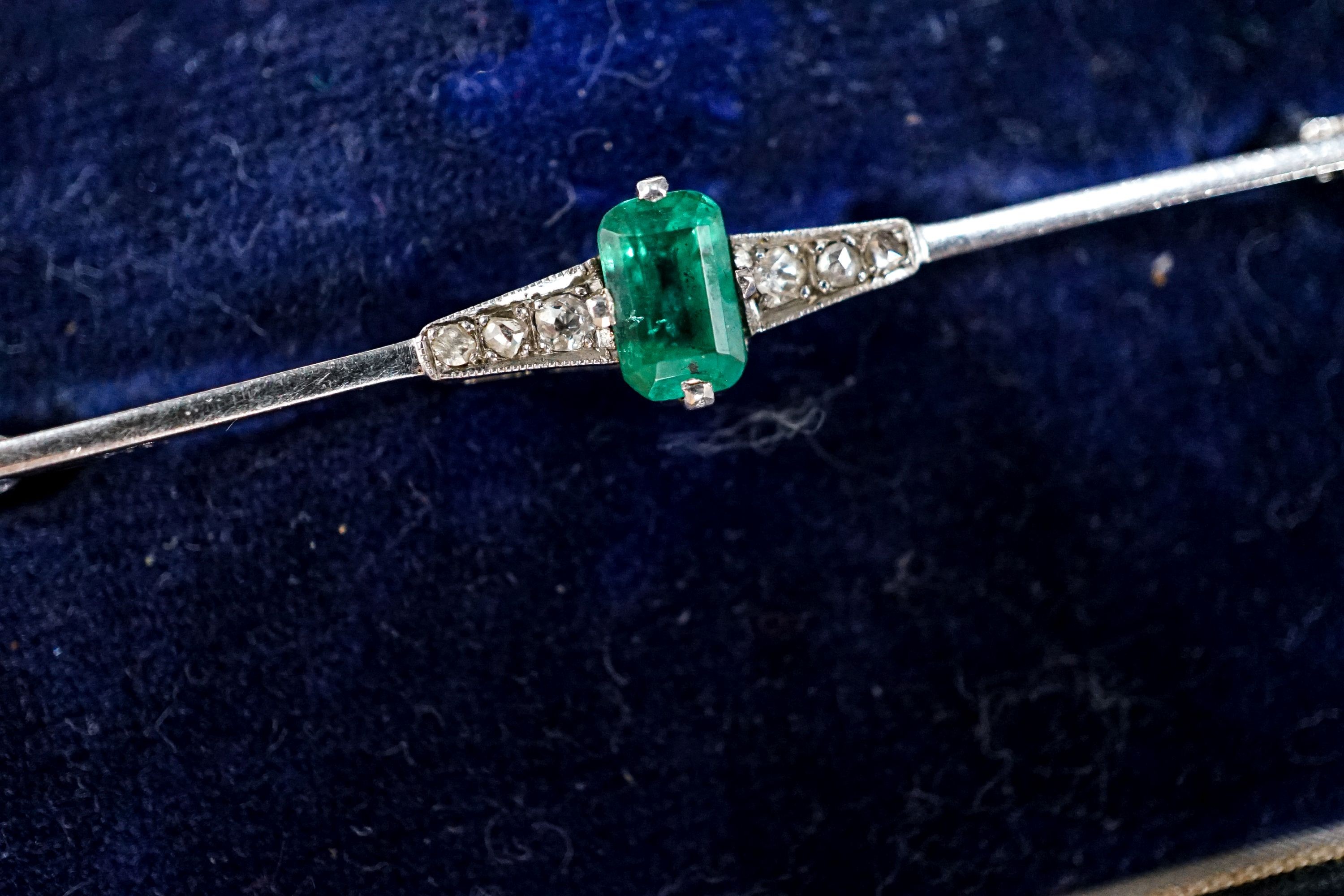 A boxed 1920's white metal (stamped pt), emerald and diamond chip set bar brooch, 51mm, gross weight 3.1 grams.